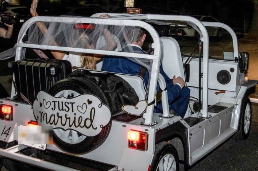 Arrière d'une Moke électrique blanche avec une pancarte Just Married pour un départ de mariage